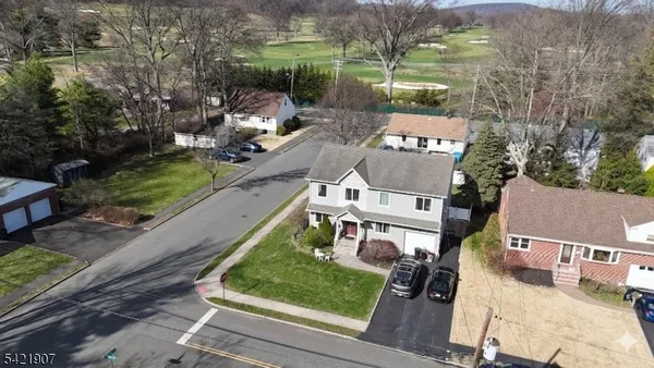 an aerial view of a house with a yard basket ball court and outdoor seating