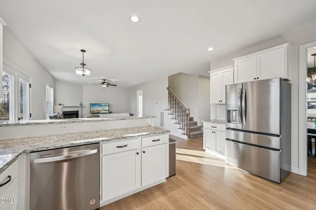 a kitchen with stainless steel appliances a refrigerator and a stove top oven