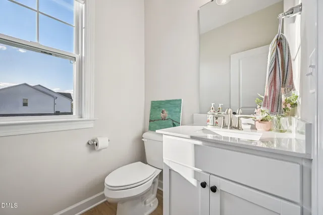 a bathroom with a sink toilet and mirror