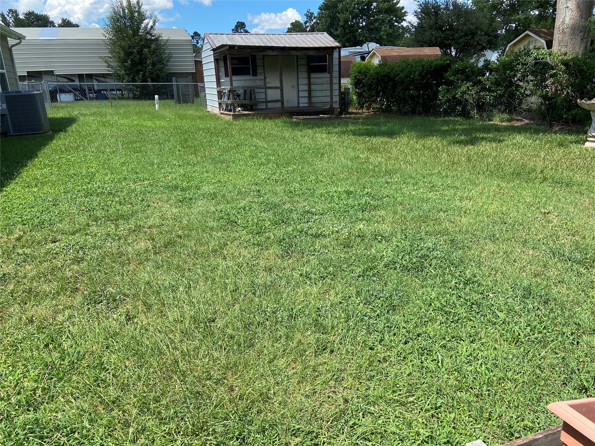 181 Hawk Livingston, TX 77399 - Photo 25 of 26 a view of a backyard with couches plants and large trees