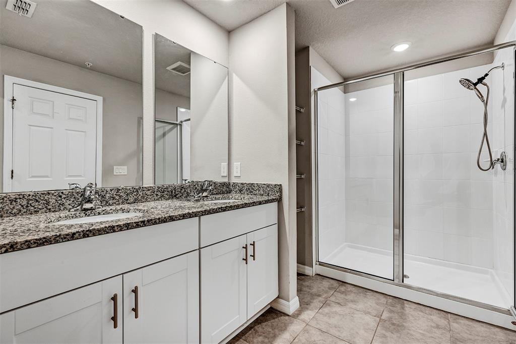 1073 Desert Candle Drive Ocoee, FL 34761 - Photo 15 of 55 a bathroom with a granite countertop sink and a mirror