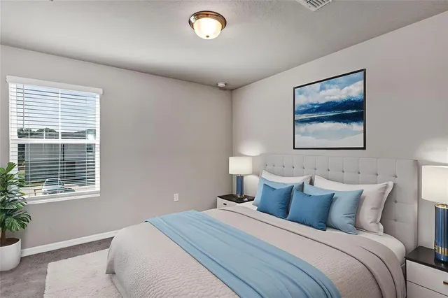 a view of an empty room with window and closet area