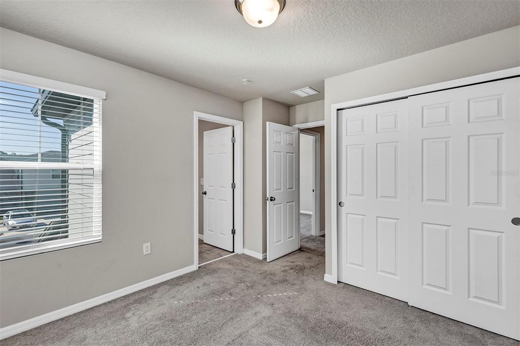 1073 Desert Candle Drive Ocoee, FL 34761 - Photo 25 of 55 a view of an empty room with window and closet area