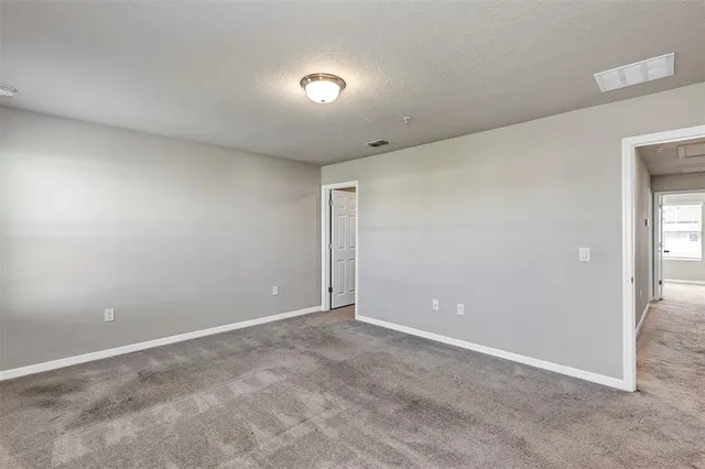 a view of an empty room and closet area