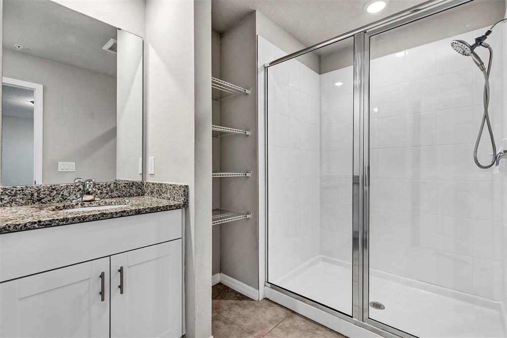 1073 Desert Candle Drive Ocoee, FL 34761 - Photo 31 of 55 a bathroom with a granite countertop shower and a sink