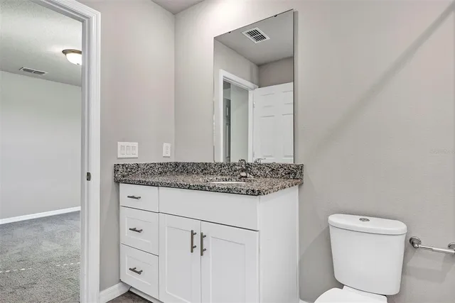 an empty room with windows and entrance to other room