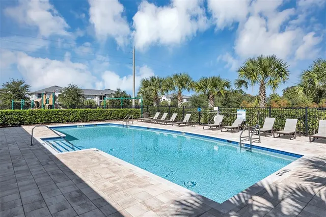 a view of a house with swimming pool and sitting area