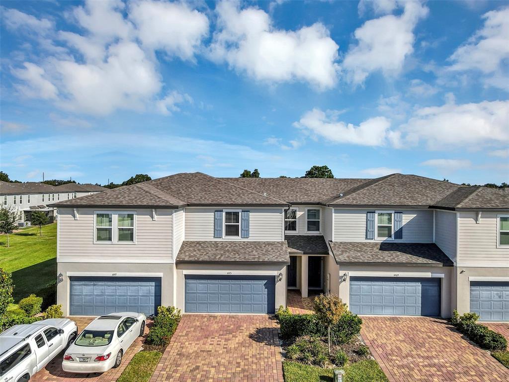 1073 Desert Candle Drive Ocoee, FL 34761 - Photo 41 of 55 a front view of a house with a yard and garage