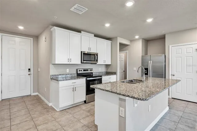 a living room with furniture kitchen and a table