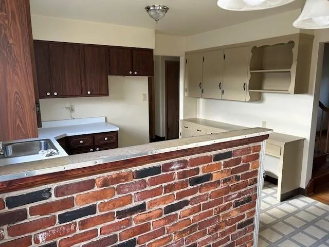 a kitchen with stainless steel appliances a cabinets and a counter top space