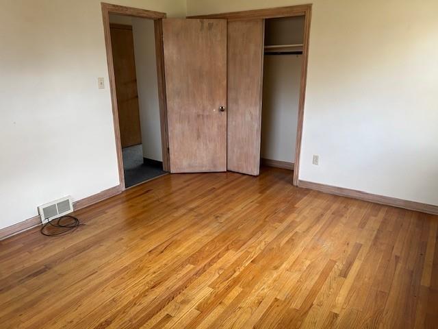 2122 Highway 130 Pleasant Unity, PA 15676 - Photo 8 of 16 an empty room with wooden floor and closet