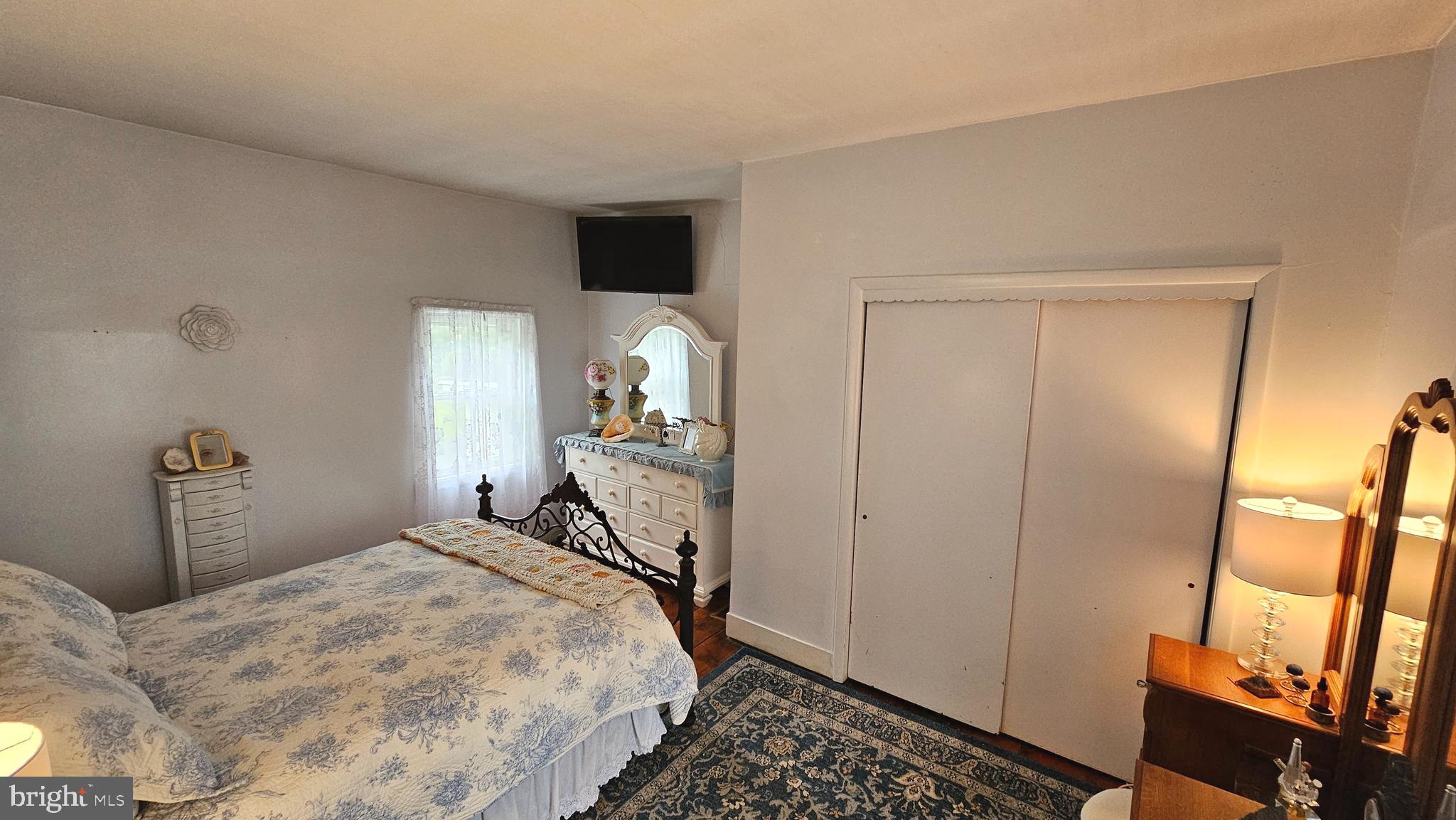 441 Dutch Neck Road East Windsor, NJ 08520 - Photo 25 of 51 a bedroom with a bed and wooden floor