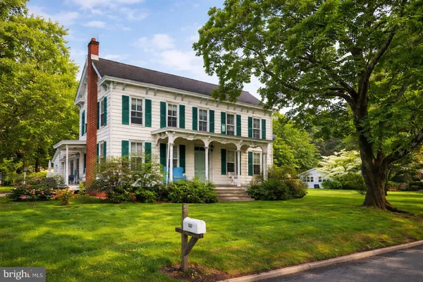 a front view of house with yard and green space