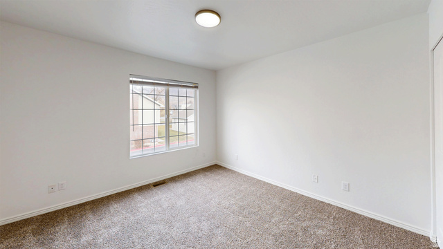 1115 North Main Street Bountiful, UT 84010 - Photo 5 of 17 Bright interior space featuring textured wall finishes, window with grids, and neutral carpeting