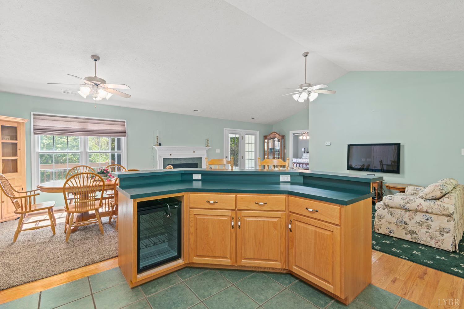 298 Braxton Ridge Road Amherst, VA 24521 - Photo 8 of 65 a kitchen with granite countertop a stove and white cabinets with wooden floor