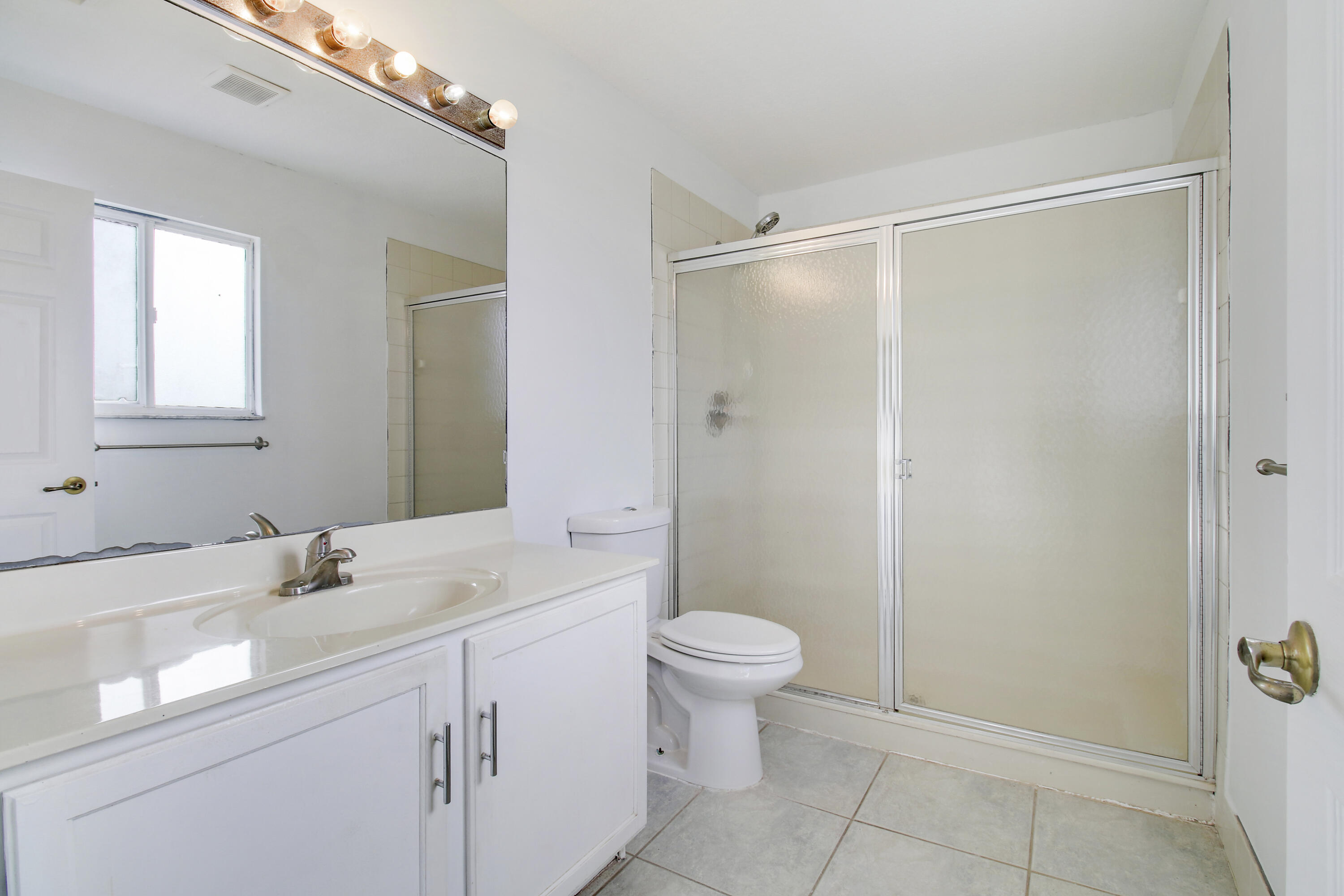 5505 Crossing Rocks Court, Unit 5505 Riviera Beach, FL 33407 - Photo 15 of 27 a bathroom with a sink toilet and shower