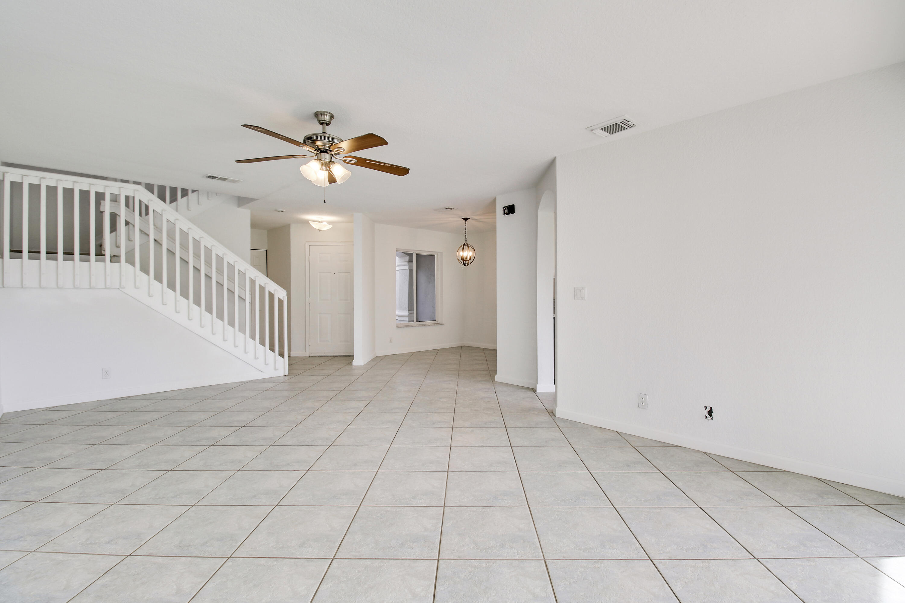 5505 Crossing Rocks Court, Unit 5505 Riviera Beach, FL 33407 - Photo 7 of 27 a view of an empty room and chandelier fan