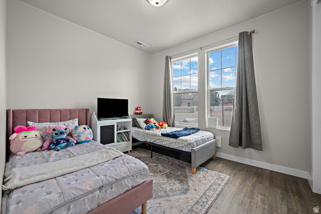 1074 South 750 West Springville, UT 84663 - Photo 18 of 28 Room featuring two large windows with vertical blinds, wood-finish flooring, and a ceiling-mounted light fixture
