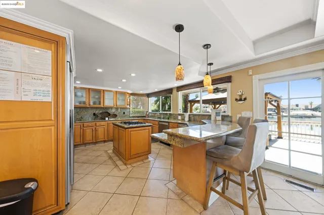 a kitchen with stainless steel appliances granite countertop a stove sink and cabinets