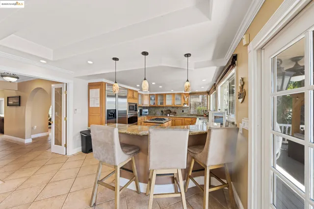 a dining room with furniture a rug and chandelier