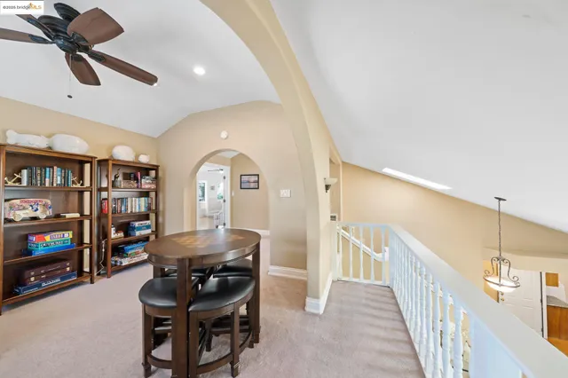 a dining room with stainless steel appliances kitchen island granite countertop a table and chairs