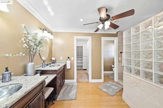 a bedroom with a bed chandelier and a window