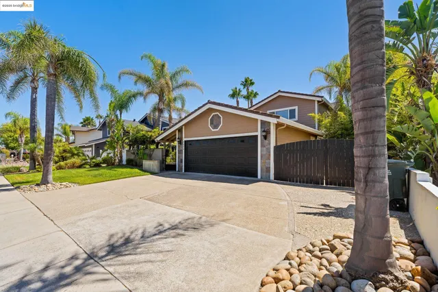 a front view of house with a yard and trees