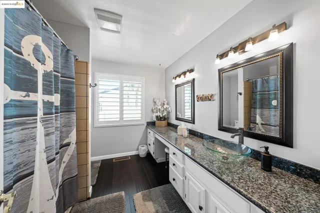 a bedroom with a large bed and a view of kitchen