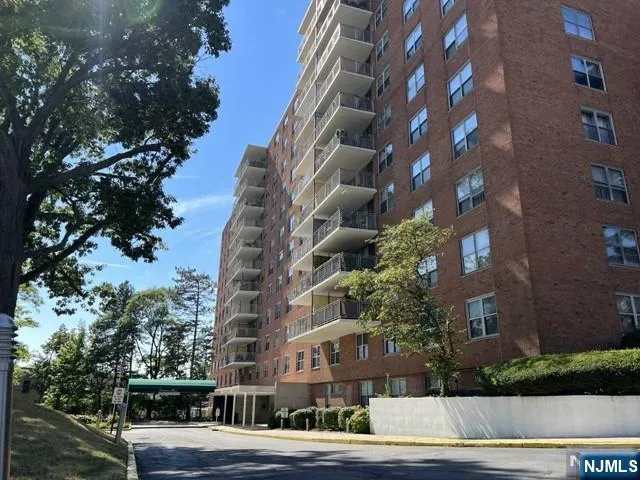 a view of a tall building next to a road