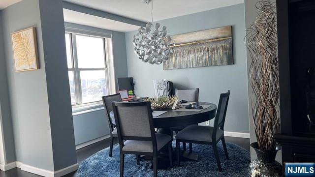 301 Beech Street, Unit 8D Hackensack, NJ 07601 - Photo 3 of 15 a dining room with furniture a chandelier and window