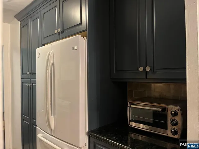 a refrigerator freezer sitting inside of a kitchen