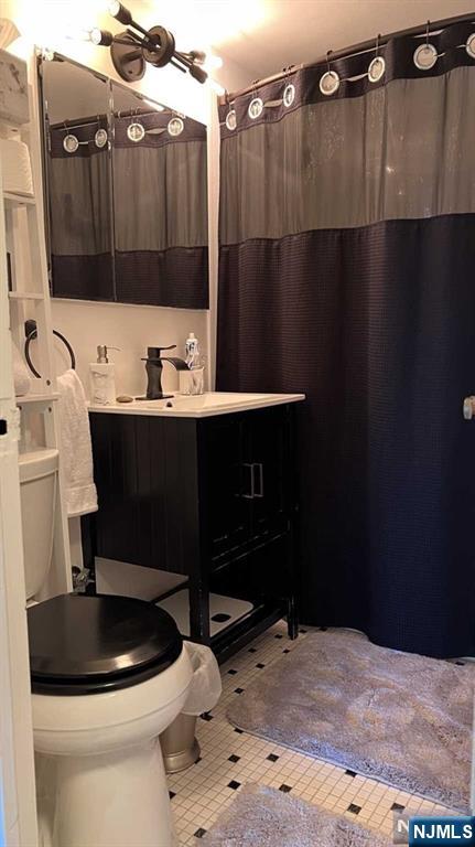 301 Beech Street, Unit 8D Hackensack, NJ 07601 - Photo 9 of 15 a bathroom with a sink a toilet and shower