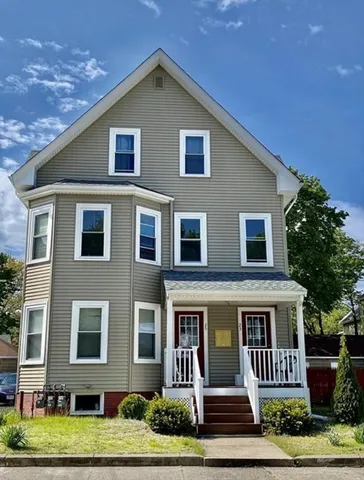 a front view of a house with a yard