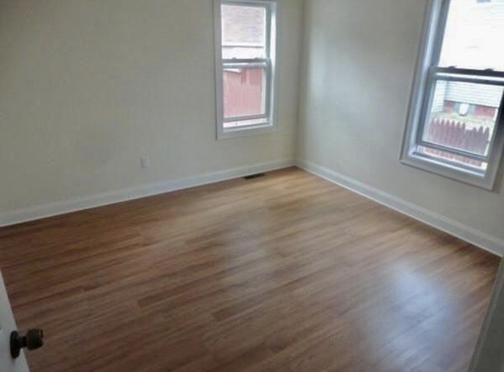 25 John Street, Unit 3 Attleboro, MA 02703 - Photo 8 of 10 an empty room with wooden floor and windows