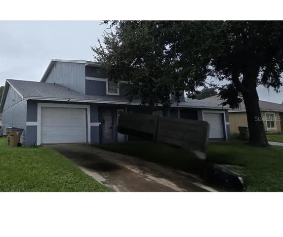 a view of house with backyard