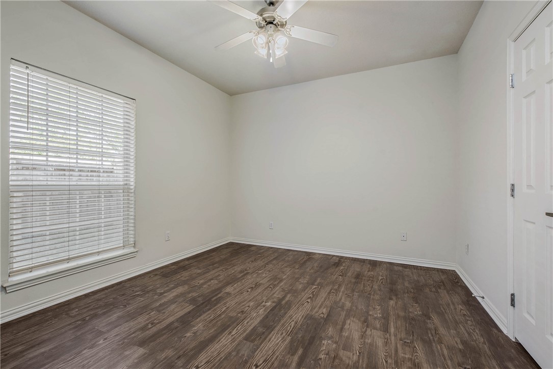 1001 Krenek Tap Road, Unit 702 College Station, TX 77840 - Photo 12 of 15 wooden floor in an empty room with a window
