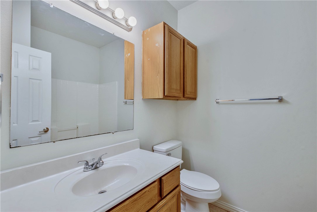 1001 Krenek Tap Road, Unit 702 College Station, TX 77840 - Photo 13 of 15 a bathroom with a sink a toilet and mirror
