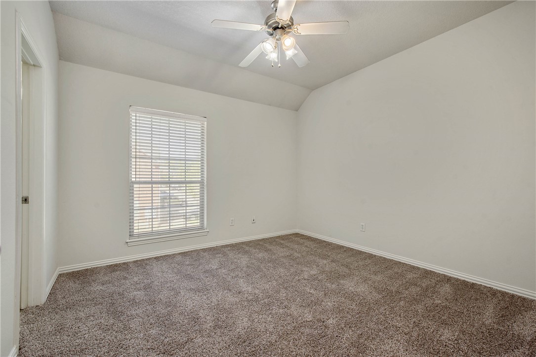1001 Krenek Tap Road, Unit 702 College Station, TX 77840 - Photo 6 of 15 an empty room with chandelier fan and windows