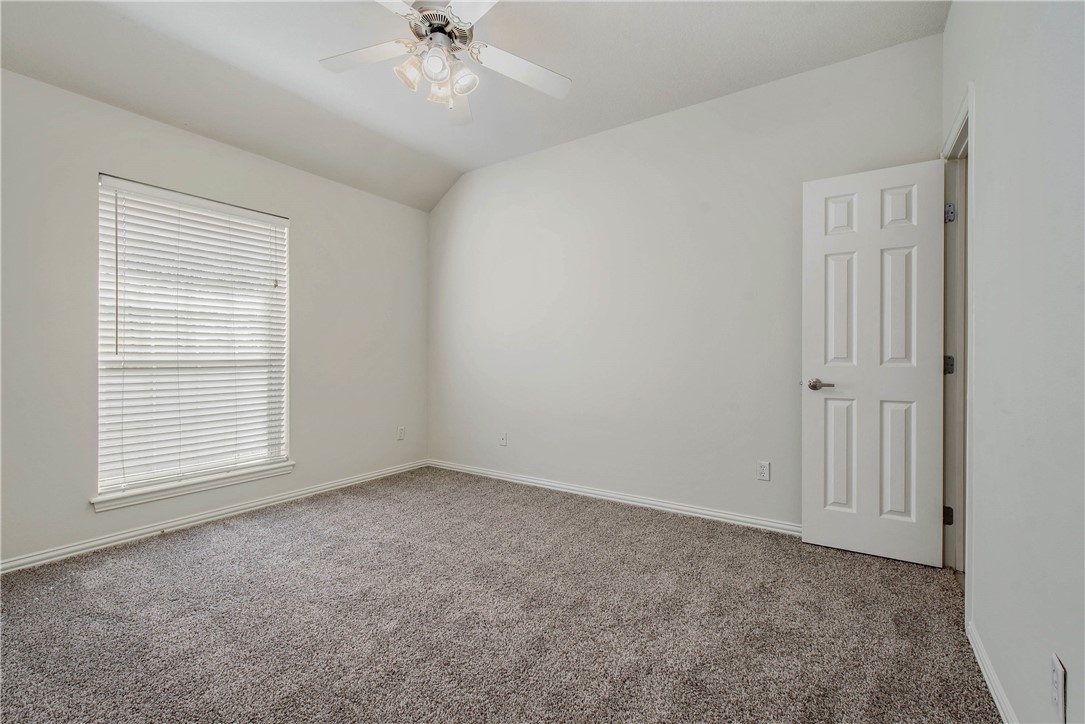 1001 Krenek Tap Road, Unit 702 College Station, TX 77840 - Photo 10 of 15 an empty room with a ceiling fan and a window