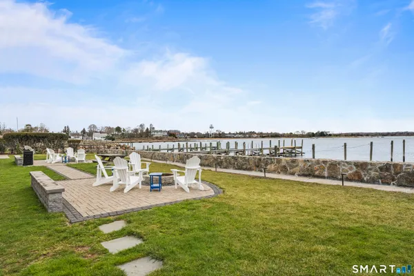 a view of a lake with couches and city view