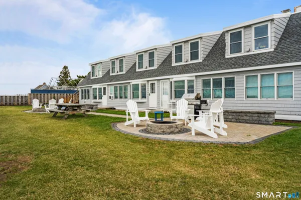 a front view of a house with swimming pool garden and patio