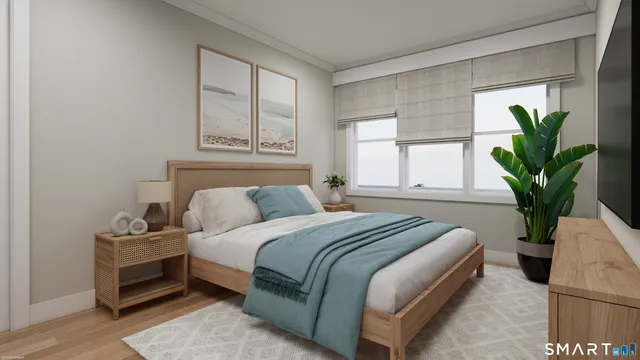 a bedroom with a bed and a potted plant