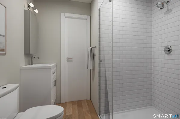 a bathroom with a toilet and a shower