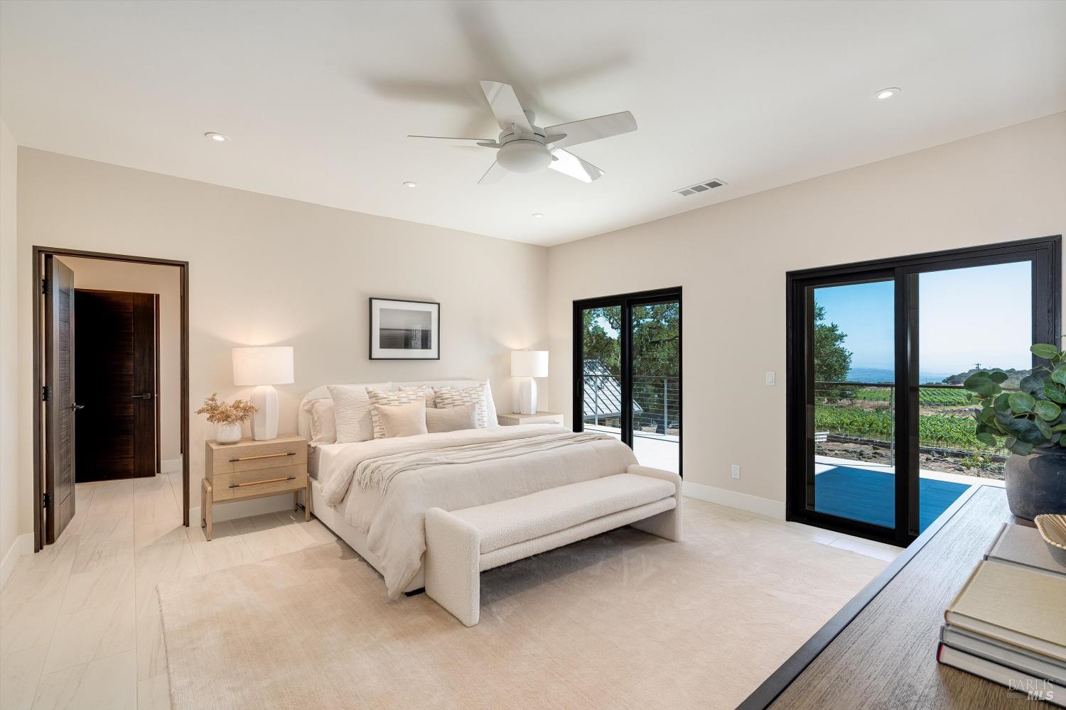 2929 Atlas Peak Road Napa, CA 94558 - Photo 20 of 56 a bedroom with a large bed and a chandelier