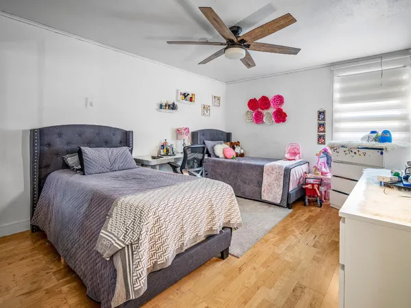 a bedroom with bed and a chandelier