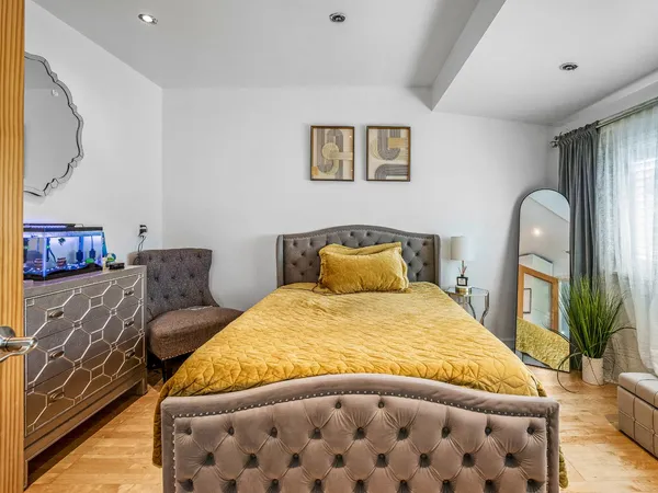 a bedroom with a large bed and a couch