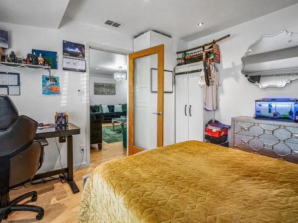 a bedroom with a bed and a desk