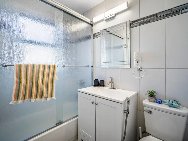 a bathroom with a sink toilet and shower