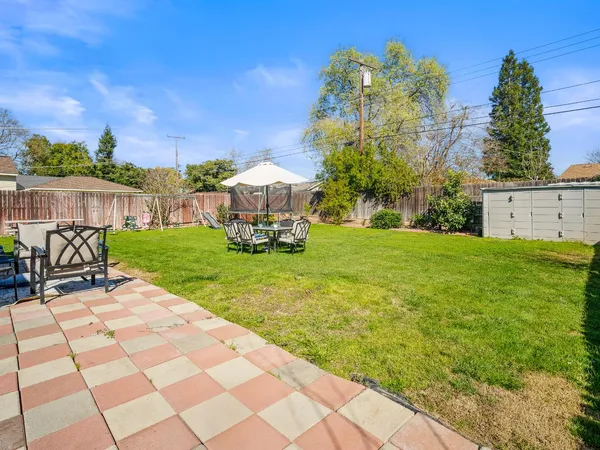 a view of a backyard with sitting area