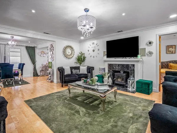 a living room with fireplace furniture a flat screen tv and a fireplace